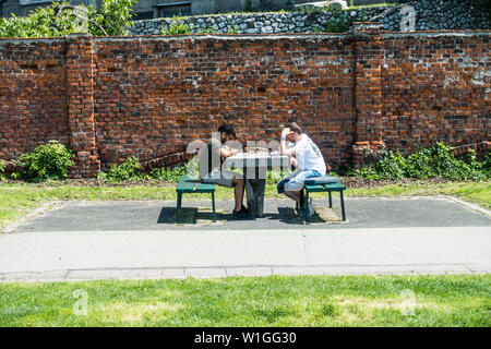 Two Men Playing Chess outside in a suburb of Krakow, Poland, Europe. Stock Photo