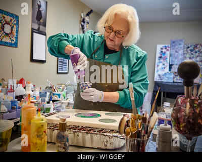 retired lady creating art in a home studio Stock Photo