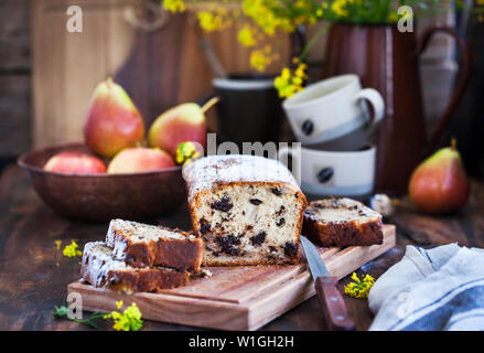 Delicious homemade chocolate and pears loaf cake on rustic wooden background Stock Photo
