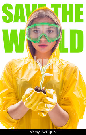 Poster "save the world" with young plant sprout in the hands of a woman in protective clothing. Stock Photo