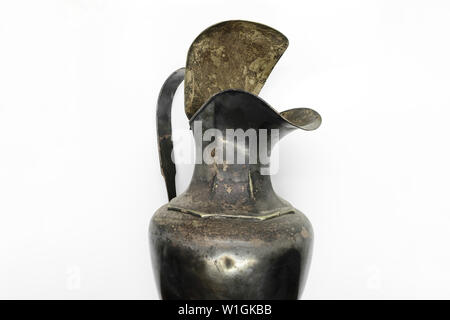 Very old and dusty part of rural metal water jar on white background Stock Photo