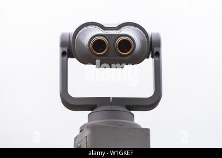 Binocular telescope on a rotating base under bright sky background Stock Photo