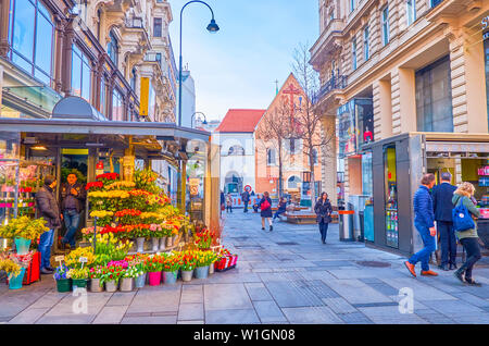 VIENNA, AUSTRIA - FEBRUARY 18, 2019: The small flower kiosk with variety of flowers on Karntner Strasse in old town, on February 18 in Vienna. Stock Photo