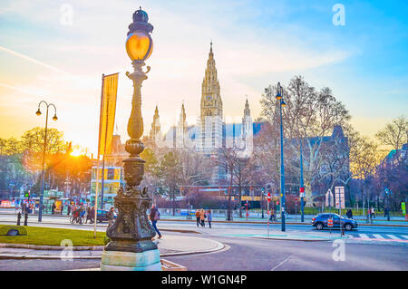 VIENNA, AUSTRIA - FEBRUARY 18, 2019: The beautiful City Hall building with high towers in Neo-Gothic style and large park with winter skating ring in Stock Photo