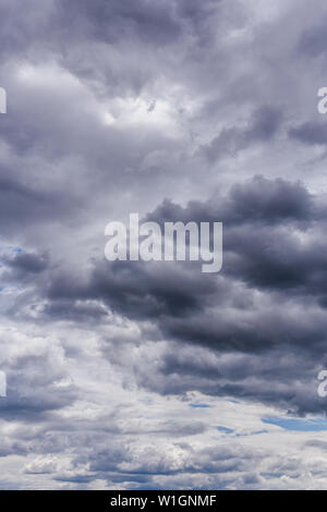 gray incoming near storm clouds daylight backdrop. Stock Photo