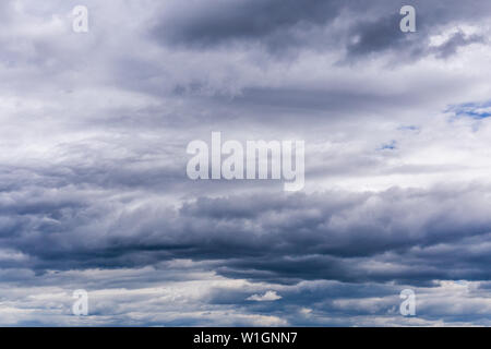 gray incoming near storm clouds daylight backdrop. Stock Photo