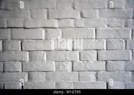 Antique white brick wall covered with paint. Stock Photo