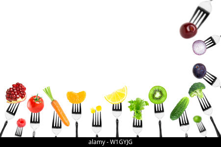 Fruits and vegetables on the forks. Healthy food Stock Photo