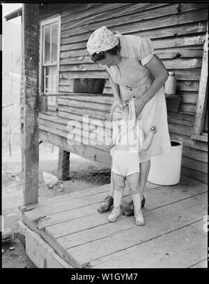 Mrs. Blaine Sergent washes her grandchild Freddy's face. P V & K Coal Company, Clover Gap Mine, Lejunior, Harlan County, Kentucky. Stock Photo