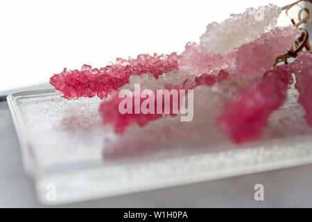 Cristalized lollipop with vibrant colors on a glass plate Stock Photo