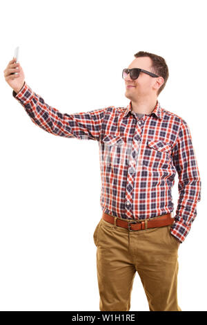 A portrait of a young fashionable man taking a selfie, isolated on white background. Stock Photo