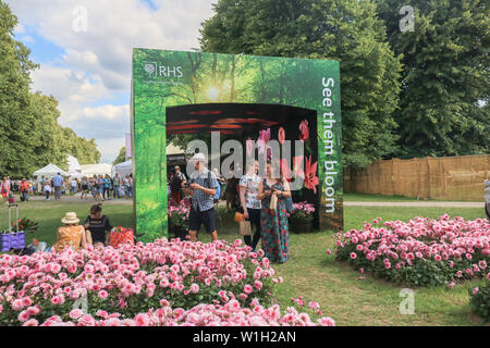 Visitors attend the show gardens.The Royal Horticultural Society (RHS) Hampton Court Garden Festival, showcases plant and flower exhibits at Hampton Court Palace in London. Stock Photo