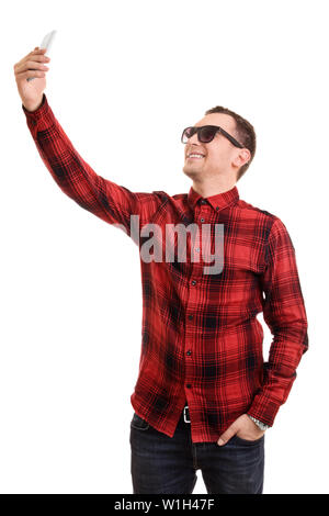 A portrait of a fashionable young man taking a selfie, isolated on white background. Stock Photo