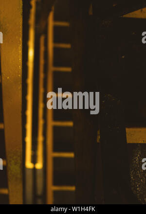 A cool yellow and black car park stairwell close up creating a pattern Stock Photo