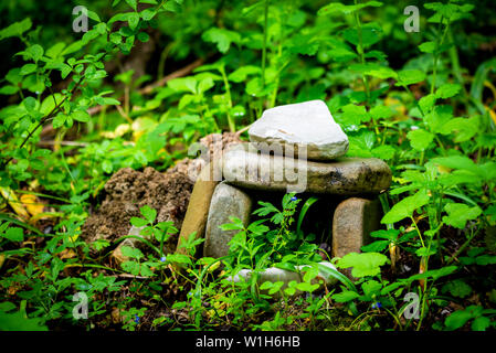 A Magic dolmen or table-stone covered by moss in Russian mountain forest. Stock Photo