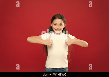 That is right. Little girl excited smiling face. Kid happy cute face feels excited red background. Exciting moments. Excitement emotion. Sincere excitement. Kid girl long hair wear casual clothes. Stock Photo