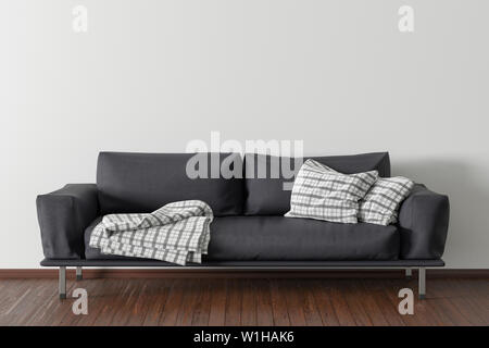 Black leather couch in interior of living room with wooden flooring and white wall Stock Photo