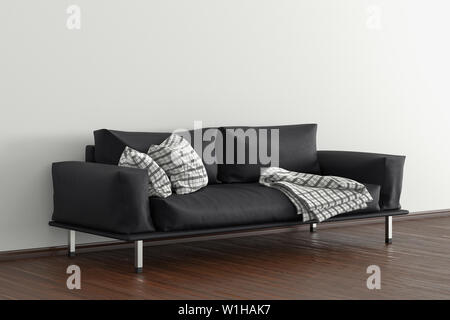 Black leather couch in interior of living room with wooden flooring and white wall Stock Photo