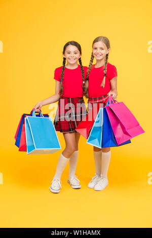 Shopping happiness. black friday. holiday presents. Sale and discount. girls shopping. happy children with shopping bags. successful shopping. big sales. school girls with packages. purchase. Stock Photo