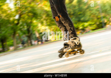 Legs rolling around on roller skates. Entertainment and leisure. Sports and Hobbies of teenagers Stock Photo