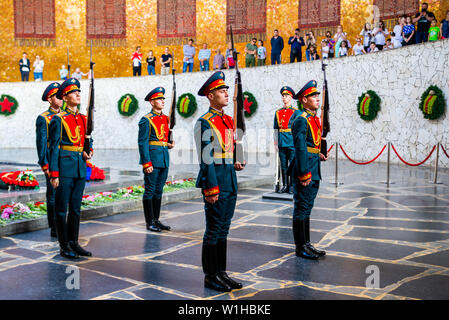 Volgograd, Russia - May 26, 2019: Change of soldiers guard in Hall of Military Glory. In centre of hall is sculpture of hand holding torch with Eterna Stock Photo