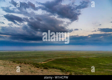 Scenic sunset with clouds in sky in steppe. Stock Photo