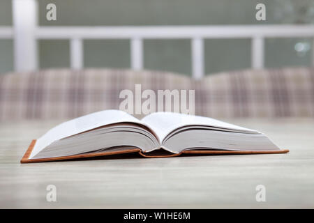 Open book on white table, education concept Stock Photo
