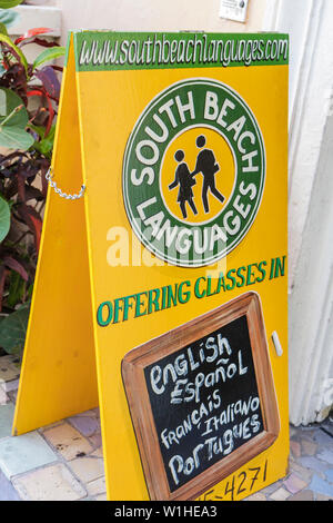 Miami Beach Florida,sign,logo,language,bilingual school,classes,English,Spanish,French,Italian,Portuguese,tent sign,visitors travel traveling tour tou Stock Photo