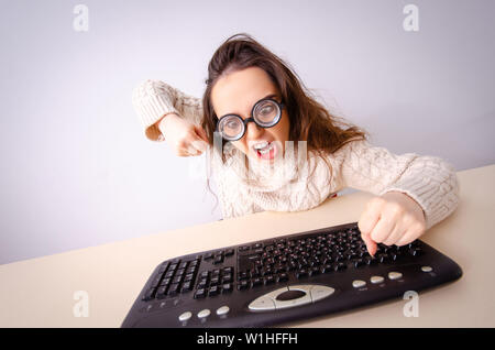 Funny nerd girl working on computer Stock Photo
