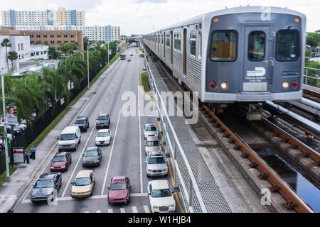 Miami Florida,NW 12th Avenue,Metrorail,public transportation,mass transit,approaching train,elevated track,parallel street,car cars,traffic,rail,visit