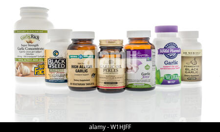 Winneconne, WI - 27 May 2019 : A collection of  garlic supplements on an isolated background Stock Photo