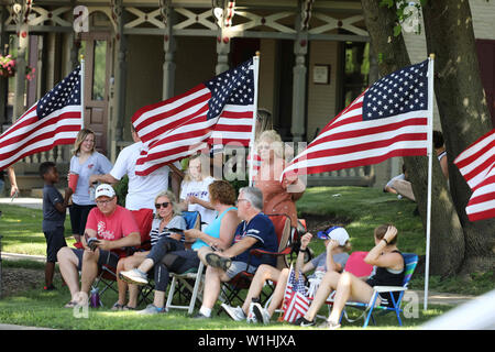 July 2, 2019 - West Dundee, Illinois, USA - Tuesday, July 2, 2019 - West Dundee, Illinois, U.S. - People wait for The Wall That Heals convoy to pass through West Dundee, Illinois on Tuesday, July 2, 2019. The Wall That Heals, is a replica of the Vietnam Veterans Memorial in Washington, DC The three-quarter scale replica wall is 375 feet in length and 7.5 feet high at its tallest point. The exhibit honors the more than 3 million Americans who served in the military during the war and bears the names of the more than 58,000 people who were killed. (Credit Image: © H. Rick Bamman/ZUMA Wire) Stock Photo