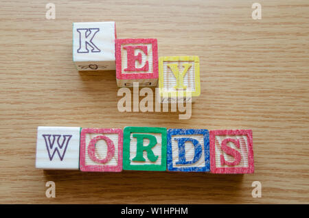 Educational toy cubes with letters organised to display word KEYWORDS - editing metadata and Search engine optimisation concept Stock Photo