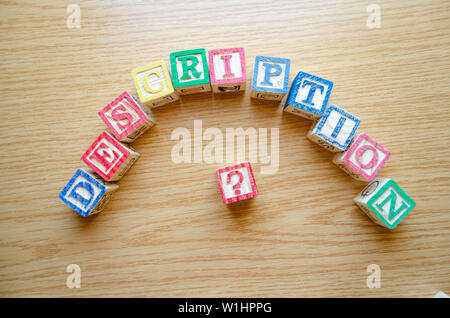 Educational toy cubes with letters organised to display word DESCRIPTION - editing metadata and Search engine optimisation concept Stock Photo