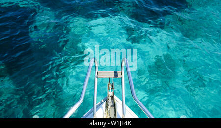 (Selective focus) Stunning view of a bow of a yacht sailing on a beautiful turquoise and transparent sea. Costa Smeralda (Emerald Coast) Sardinia. Stock Photo