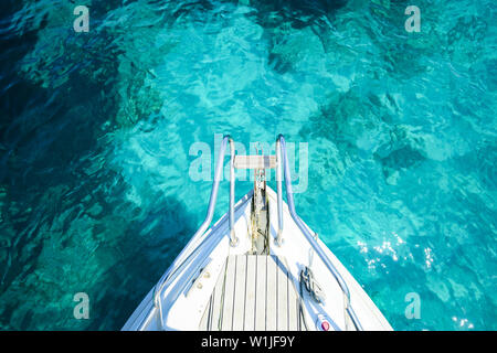 (Selective focus) Stunning view of a bow of a yacht sailing on a beautiful turquoise and transparent sea. Costa Smeralda (Emerald Coast) Sardinia. Stock Photo