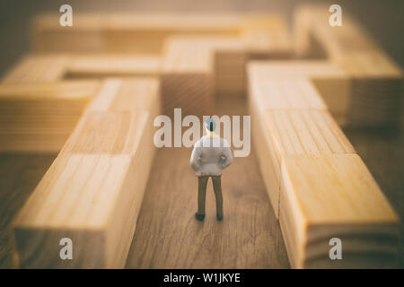 business concept image of and challenge. A man stands in the maze looking for the exit. Problem solving and decision making idea Stock Photo