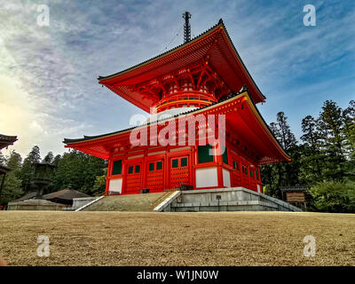 The vibrant red Konpon Daito Pagoda in the Unesco listed Danjo Garan shingon buddhism temple complex in Koyasan, Wakayama, Japan. A famous pilgrimage. Stock Photo