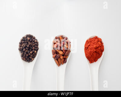 spicy spices in white spoons on white background Stock Photo