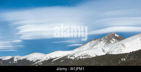 Elongated lenticular clouds form a pattern over the ridgeline off James Peak as seen from Berthoud Pass near Winter Park, Colorado. (c) 2015 Tom Kelly Stock Photo