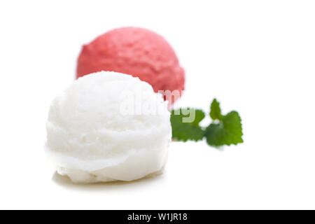 A red and a white scoop of ice cream with mint leaves isolated on white background Stock Photo