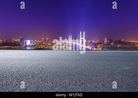 Empty road and Nanpu bridge at night in Shanghai,China Stock Photo