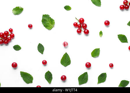 Fruit pattern made of fresh berries and green leaves on white background. Concept of healthy food. Flat lay, top view, copy space Stock Photo