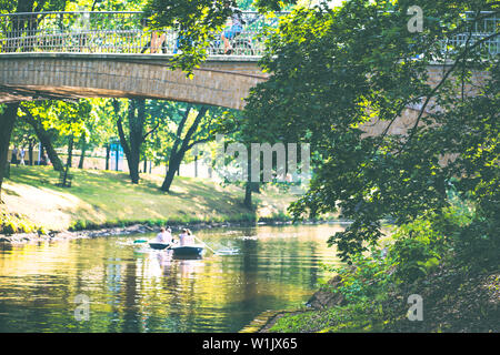 Kayaks and pleasure boats on the city canal in the city of Riga in summer Stock Photo