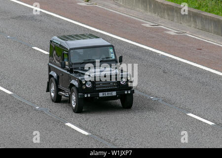 2010 black Land Rover Defender 90 Hard TOP TD; M6, Lancaster, UK; Vehicular traffic, transport, modern, saloon cars, north-bound on the 3 lane highway. Stock Photo