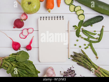 Meal plan of menu concept. Empty paper mock-up in the cener of different vegetables and fruits, top view Stock Photo