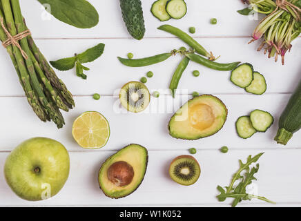 Creative composition with different green colored vegetables and fruits on the white background, top view Stock Photo