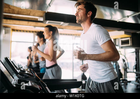 Happy gorup of healthy people training in gym Stock Photo