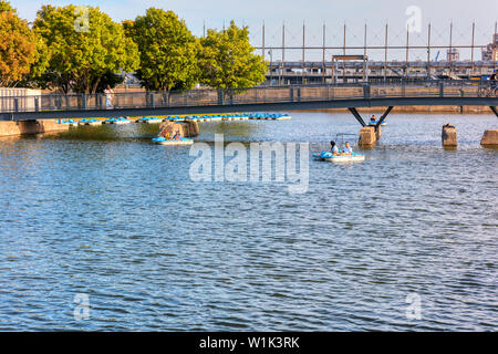 People cruising on pedalo boat over the St. Lawrence river in old port, Montreal, Quebec, Canada. Stock Photo