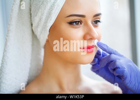 Skin care. Experienced cosmetician pulling out brows Stock Photo